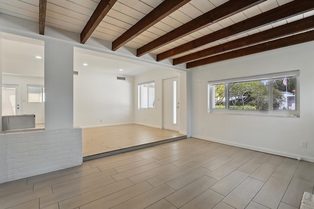 unfurnished living room featuring beam ceiling, recessed lighting, baseboards, wooden ceiling, and visible vents
