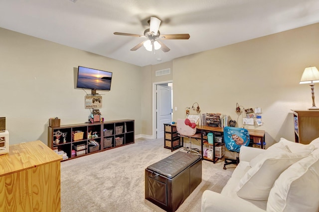 living room featuring a ceiling fan and carpet