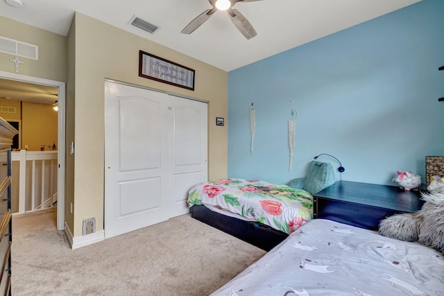 carpeted bedroom featuring a closet, a ceiling fan, and baseboards
