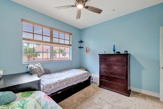 carpeted bedroom with baseboards and a ceiling fan