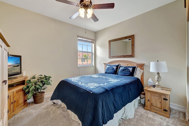bedroom with baseboards, light colored carpet, and ceiling fan
