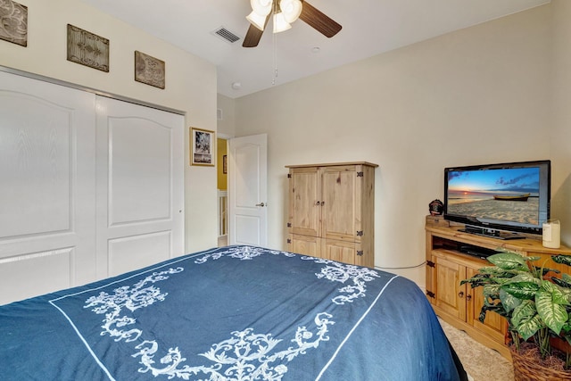 bedroom with a ceiling fan, carpet, and a closet