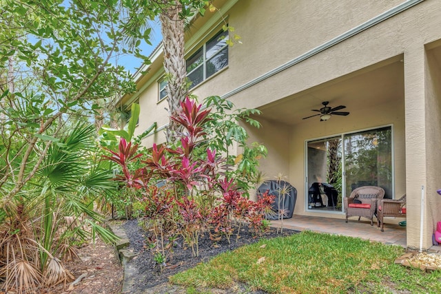 exterior space featuring ceiling fan, stucco siding, and a patio area