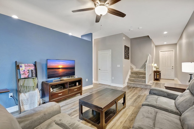 living room with stairway, light wood-type flooring, a ceiling fan, baseboards, and recessed lighting