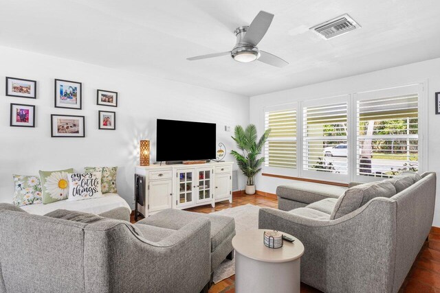 2701 SW 4th St, Boynton Beach, FL 33435 - living room with a ceiling fan, baseboards, visible vents, and plenty of natural light
