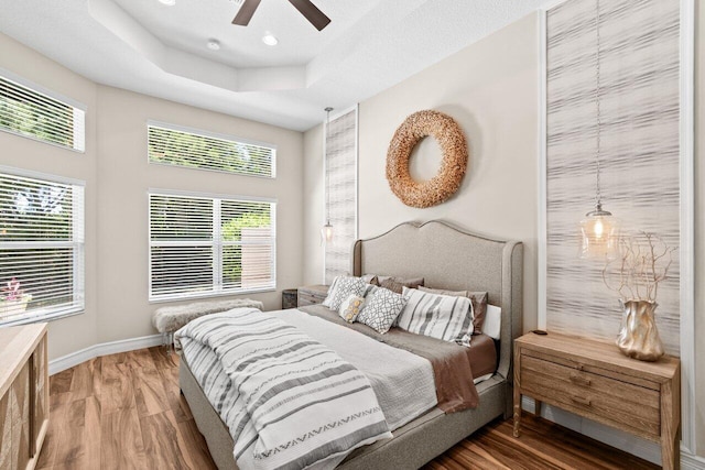 8673 Carmel Mountain Way, Boynton Beach, FL 33473 - bedroom featuring wood finished floors, multiple windows, a raised ceiling, and recessed lighting