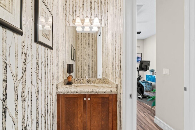 8673 Carmel Mountain Way, Boynton Beach, FL 33473 - bathroom with vanity, wood finished floors, a chandelier, and baseboards