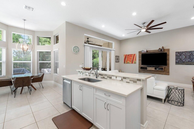 8673 Carmel Mountain Way, Boynton Beach, FL 33473 - kitchen featuring dishwasher, a sink, open floor plan, light tile patterned floors, and plenty of natural light