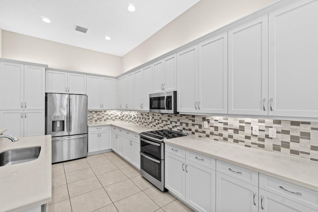 8673 Carmel Mountain Way, Boynton Beach, FL 33473 - kitchen with stainless steel appliances, a sink, light countertops, decorative backsplash, and recessed lighting