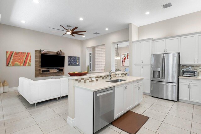 8673 Carmel Mountain Way, Boynton Beach, FL 33473 - kitchen with stainless steel appliances, open floor plan, a sink, light tile patterned flooring, and recessed lighting