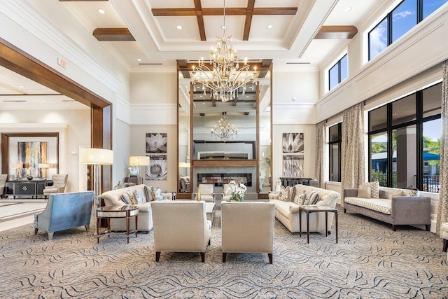 8673 Carmel Mountain Way, Boynton Beach, FL 33473 - carpeted living area featuring a chandelier, a high ceiling, a glass covered fireplace, beam ceiling, and coffered ceiling