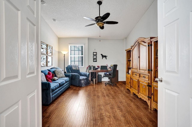home office with a textured ceiling, a ceiling fan, and dark wood-style floors