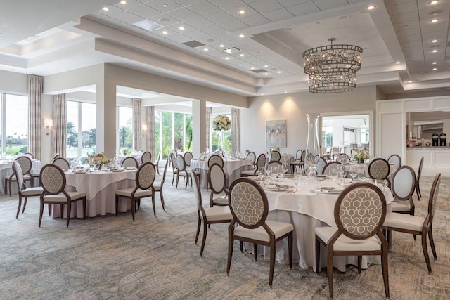 dining room with carpet floors, a tray ceiling, a chandelier, healthy amount of natural light, and recessed lighting