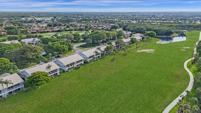 aerial view of property and surrounding area featuring a nearby body of water and nearby suburban area