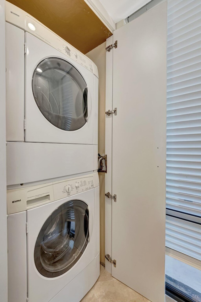 2707 N Ocean Blvd Unit D506, Boca Raton, FL 33431 - clothes washing area with laundry area, light tile patterned floors, and stacked washer / drying machine