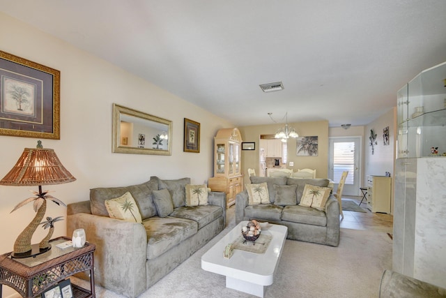 living area with carpet flooring, a chandelier, and visible vents