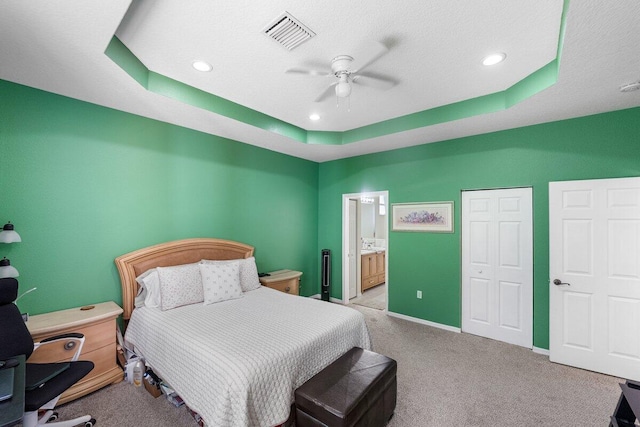 846 SW Rocky Bayou Ter, Port Saint Lucie, FL 34986 - bedroom with a tray ceiling, carpet flooring, connected bathroom, recessed lighting, and ceiling fan