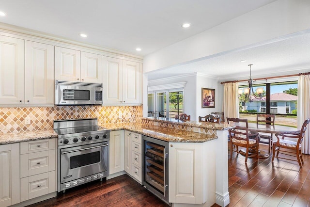 3980 Quail Ridge Dr Egret, Unit Egret, Boynton Beach, FL 33436 - kitchen featuring a peninsula, wine cooler, tasteful backsplash, dark wood finished floors, and stainless steel appliances