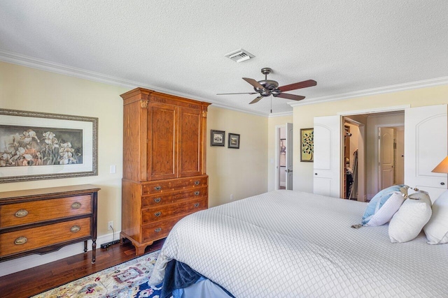 3980 Quail Ridge Dr Egret, Unit Egret, Boynton Beach, FL 33436 - bedroom featuring a textured ceiling, ornamental molding, wood finished floors, and visible vents