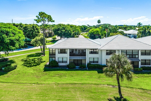 3980 Quail Ridge Dr Egret, Unit Egret, Boynton Beach, FL 33436 - back of property with a yard, a tile roof, and a balcony