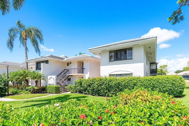 3980 Quail Ridge Dr Egret, Unit Egret, Boynton Beach, FL 33436 - view of front of house with a front lawn, stucco siding, and stairway