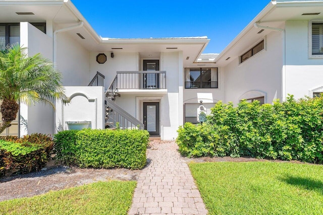3980 Quail Ridge Dr Egret, Unit Egret, Boynton Beach, FL 33436 - view of exterior entry with stucco siding