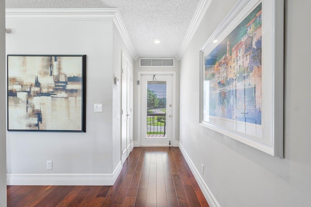 3980 Quail Ridge Dr Egret, Unit Egret, Boynton Beach, FL 33436 - doorway to outside featuring crown molding, a textured ceiling, dark wood finished floors, baseboards, and visible vents