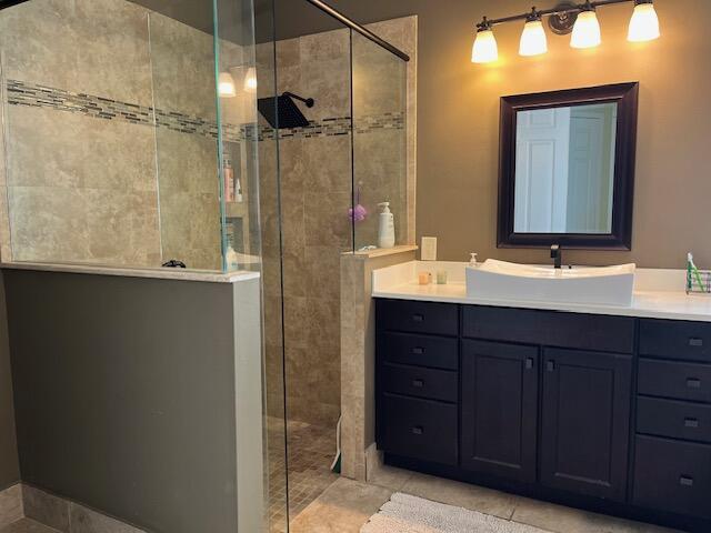 bathroom with vanity and tiled shower