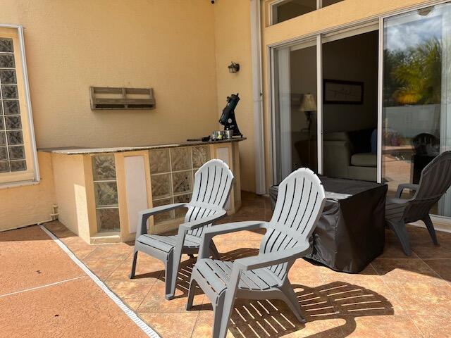 212 NW Pleasant Grove Way, Port Saint Lucie, FL 34986 - view of patio / terrace with a wall unit AC