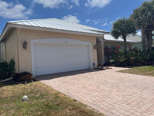 garage with decorative driveway