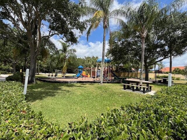 community jungle gym featuring a yard