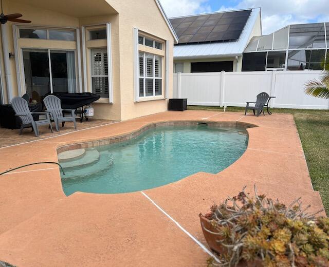 view of swimming pool featuring fence, a patio area, and a fenced in pool