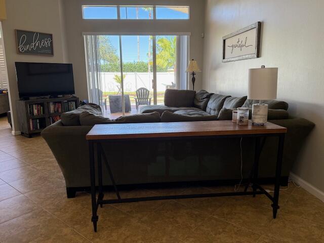 212 NW Pleasant Grove Way, Port Saint Lucie, FL 34986 - living room with tile patterned floors and baseboards
