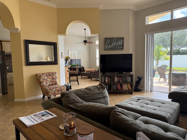 212 NW Pleasant Grove Way, Port Saint Lucie, FL 34986 - living room with crown molding, arched walkways, a ceiling fan, healthy amount of natural light, and a high ceiling
