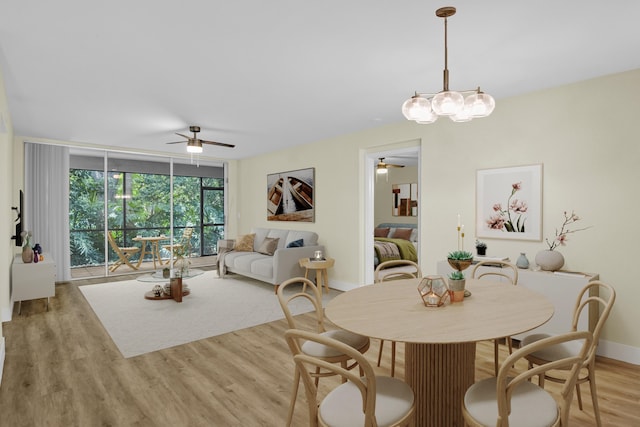 9746 Nickels Blvd Unit 103, Boynton Beach, FL 33436 - dining room with a ceiling fan, baseboards, a wall of windows, and wood finished floors
