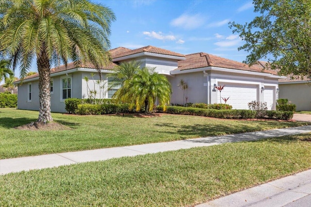 12133 SW Aventino Dr, Port Saint Lucie, FL 34987 - mediterranean / spanish-style house featuring a tiled roof, stucco siding, a garage, and a front yard
