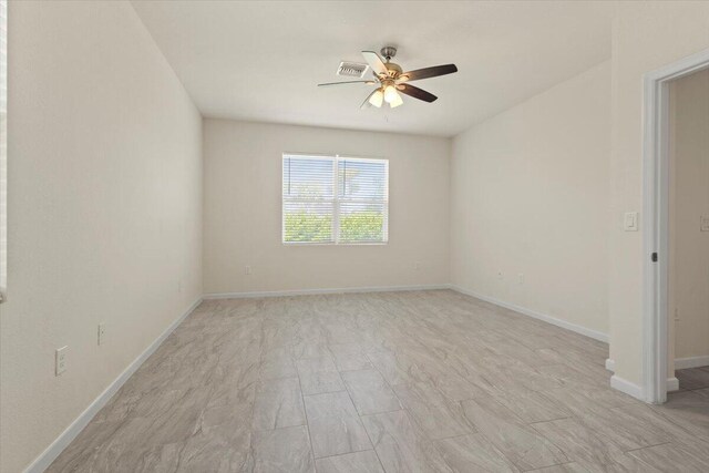 12133 SW Aventino Dr, Port Saint Lucie, FL 34987 - spare room featuring a ceiling fan and baseboards