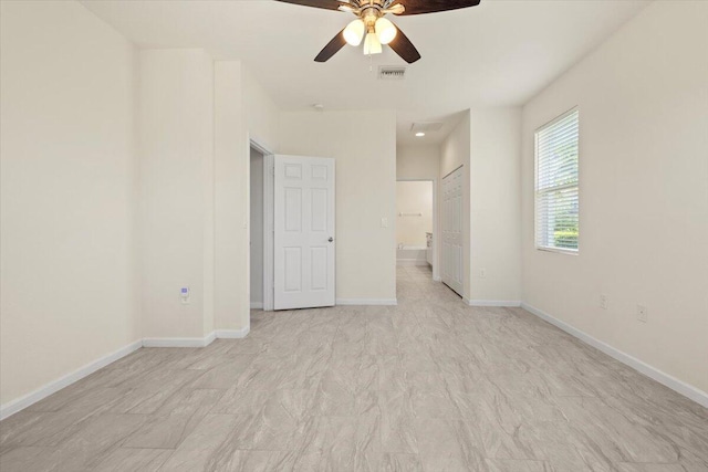 12133 SW Aventino Dr, Port Saint Lucie, FL 34987 - unfurnished bedroom featuring baseboards, ensuite bathroom, ceiling fan, and a closet
