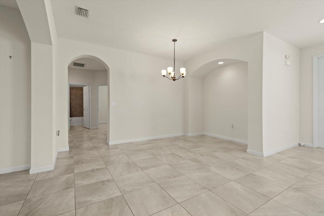 12133 SW Aventino Dr, Port Saint Lucie, FL 34987 - empty room featuring arched walkways, a chandelier, recessed lighting, and baseboards