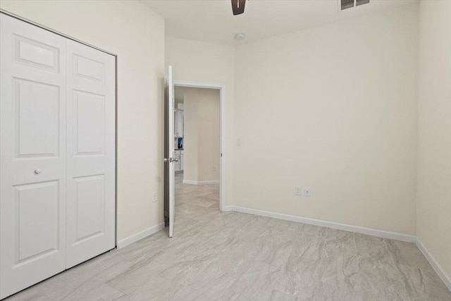 12133 SW Aventino Dr, Port Saint Lucie, FL 34987 - unfurnished bedroom with a closet, baseboards, and a ceiling fan
