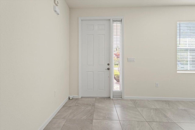 12133 SW Aventino Dr, Port Saint Lucie, FL 34987 - entryway featuring baseboards, healthy amount of natural light, and light tile patterned flooring