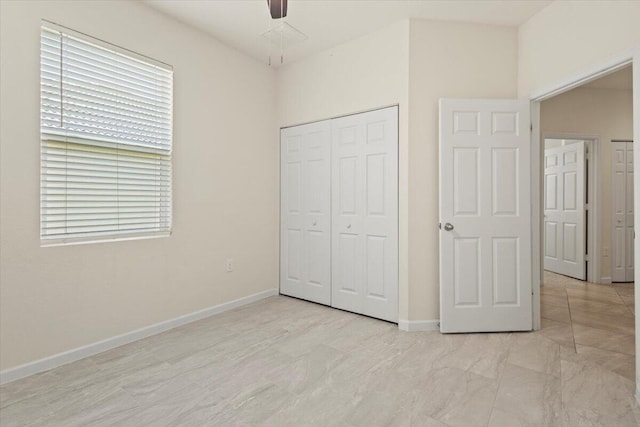 12133 SW Aventino Dr, Port Saint Lucie, FL 34987 - unfurnished bedroom featuring a closet, baseboards, a ceiling fan, and multiple windows