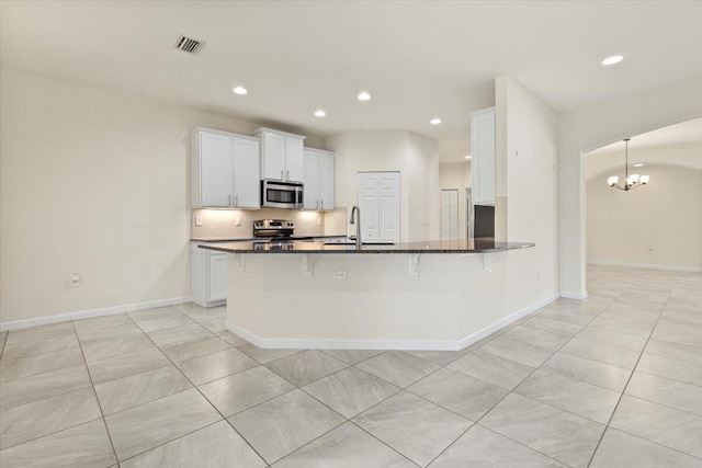 12133 SW Aventino Dr, Port Saint Lucie, FL 34987 - kitchen featuring stainless steel appliances, a sink, recessed lighting, white cabinetry, and tasteful backsplash