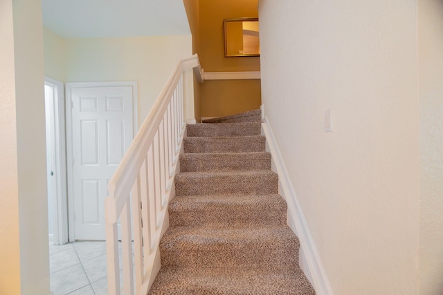 stairs featuring carpet flooring and baseboards