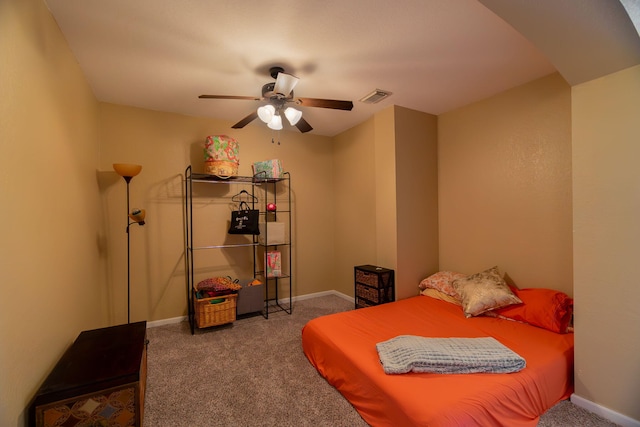 carpeted bedroom with visible vents, a ceiling fan, and baseboards