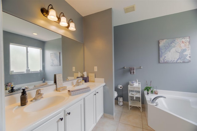bathroom with tile patterned flooring, a garden tub, visible vents, double vanity, and a sink