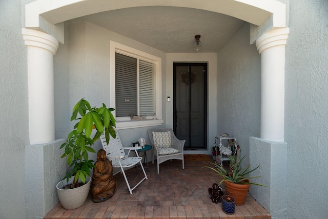 view of exterior entry featuring stucco siding