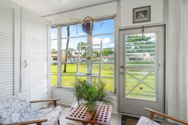 sunroom featuring french doors and a wealth of natural light