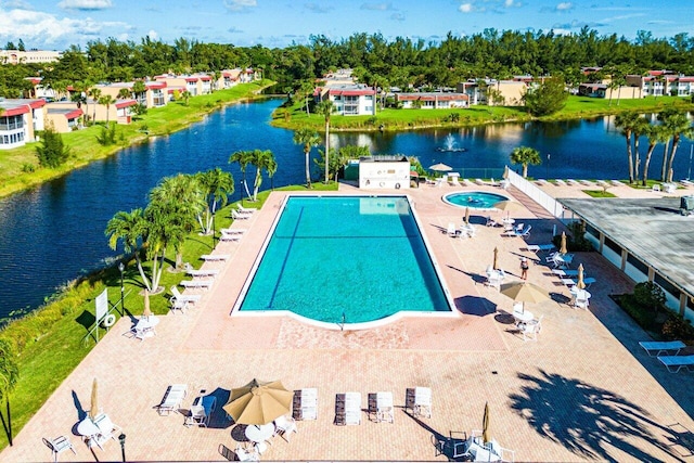 pool with a water view and a patio area