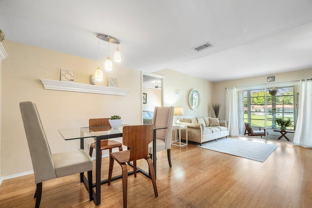 dining room with wood finished floors and visible vents